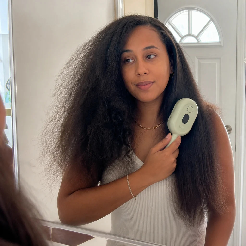 Customer using Mistglide Brush near an entryway mirror